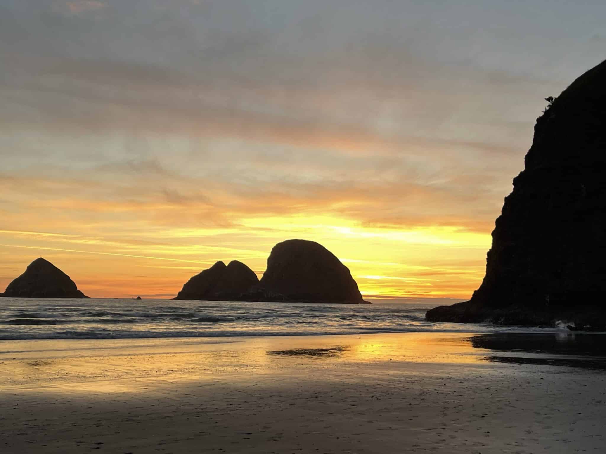 bright orange sunset at Tunnel Beach in Oceanside Oregon