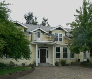 Yellow two story house that is Airlie Farm Bed and Breakfast