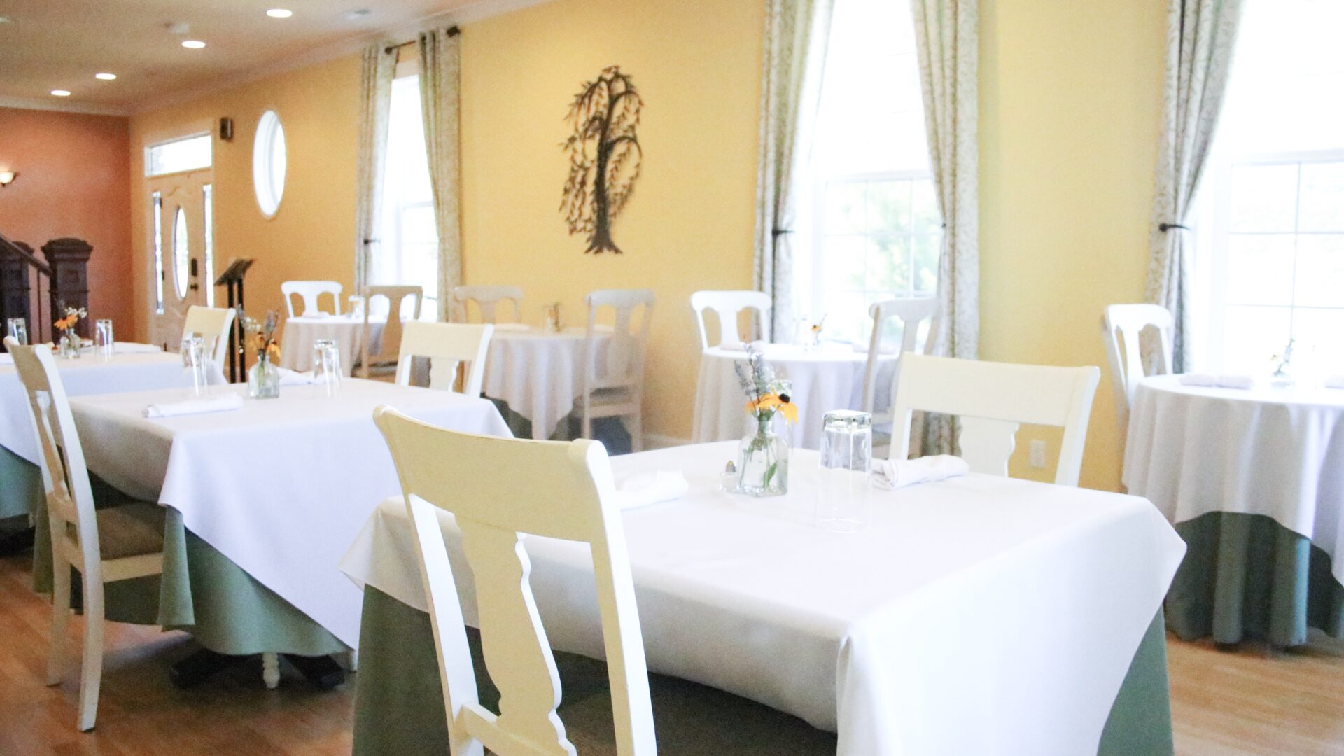 gold colored La Bastide Dining room with white table clothes