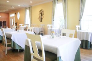 gold colored La Bastide Dining room with white table clothes