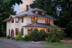 Two story beige house with brown roof and trim. Old Parkdale Inn Bed and Breakfast