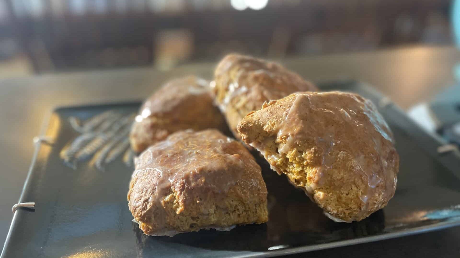 Golden Pumpkin Spice Scones on a dark green platter