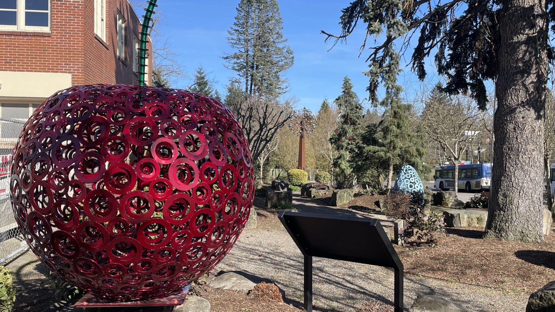 A large red Bing Cherry Sculpture in Milwaukie Oregon Sculpture Garden