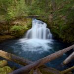 Rogue - Umpqua Scenic Byway waterfall with drift logs