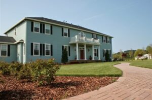 large blue house with white and green trim that is La Bastide Bed and Breakfast