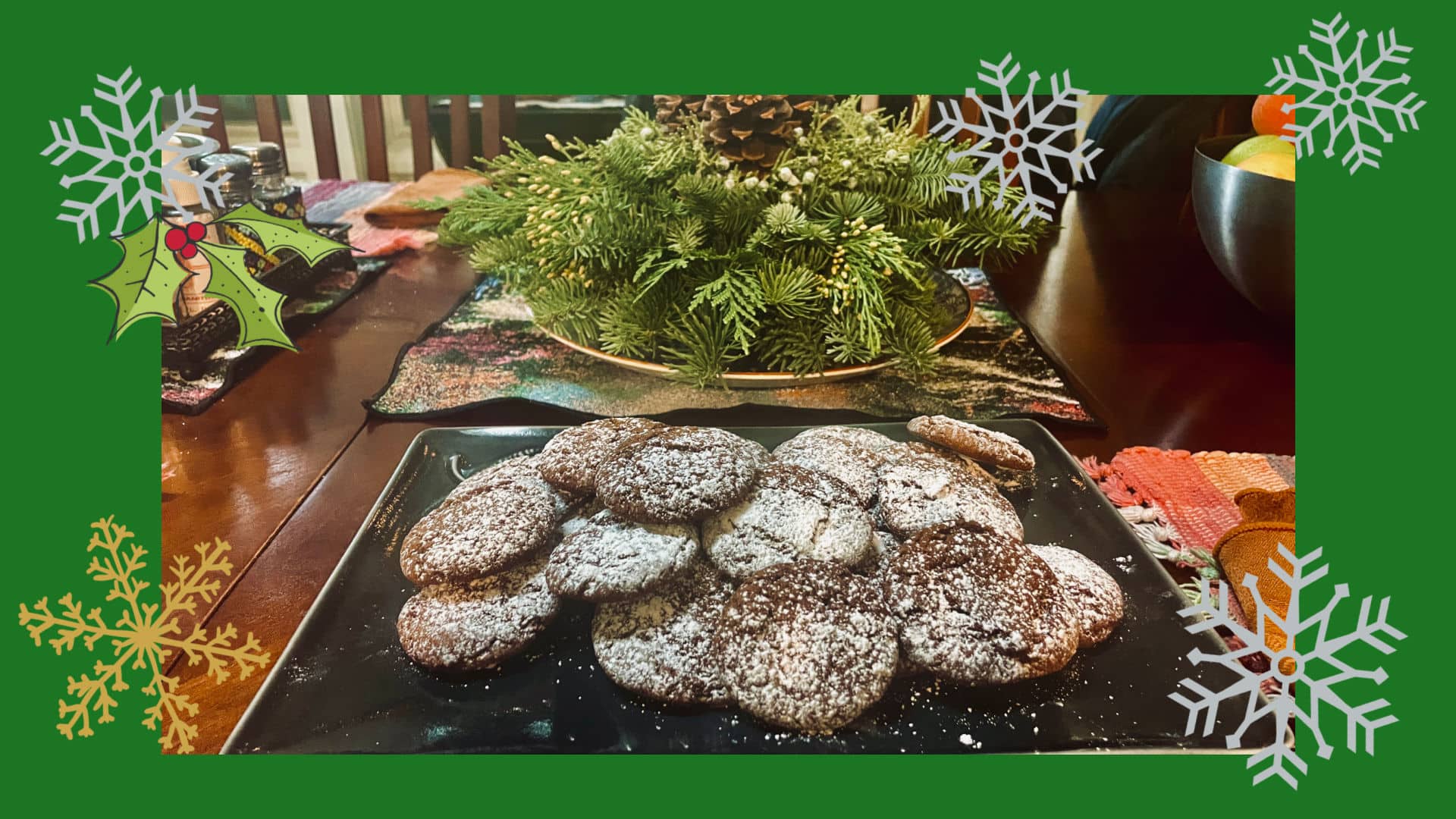 Pfeffernüsse on a green platter surrounded by evergreen boughs