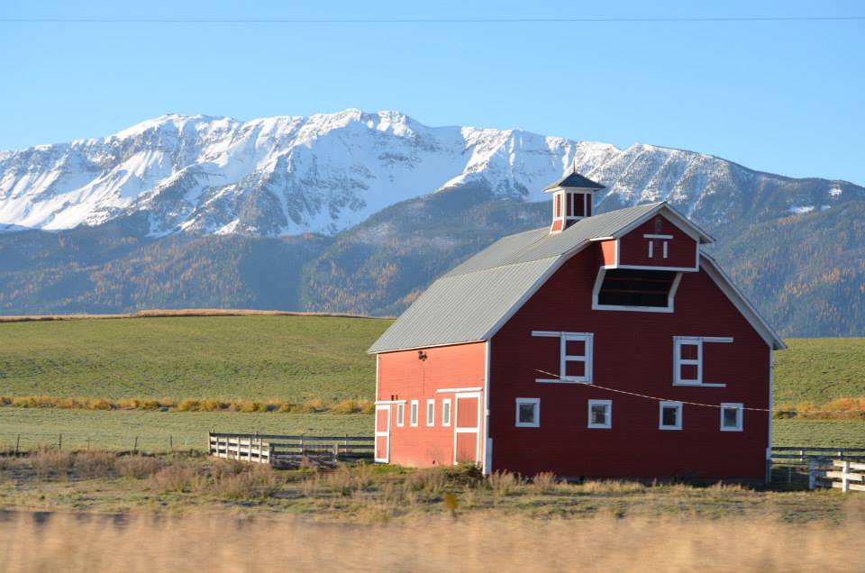 Red Barn with snow capped mountains in the Wallowa Valley