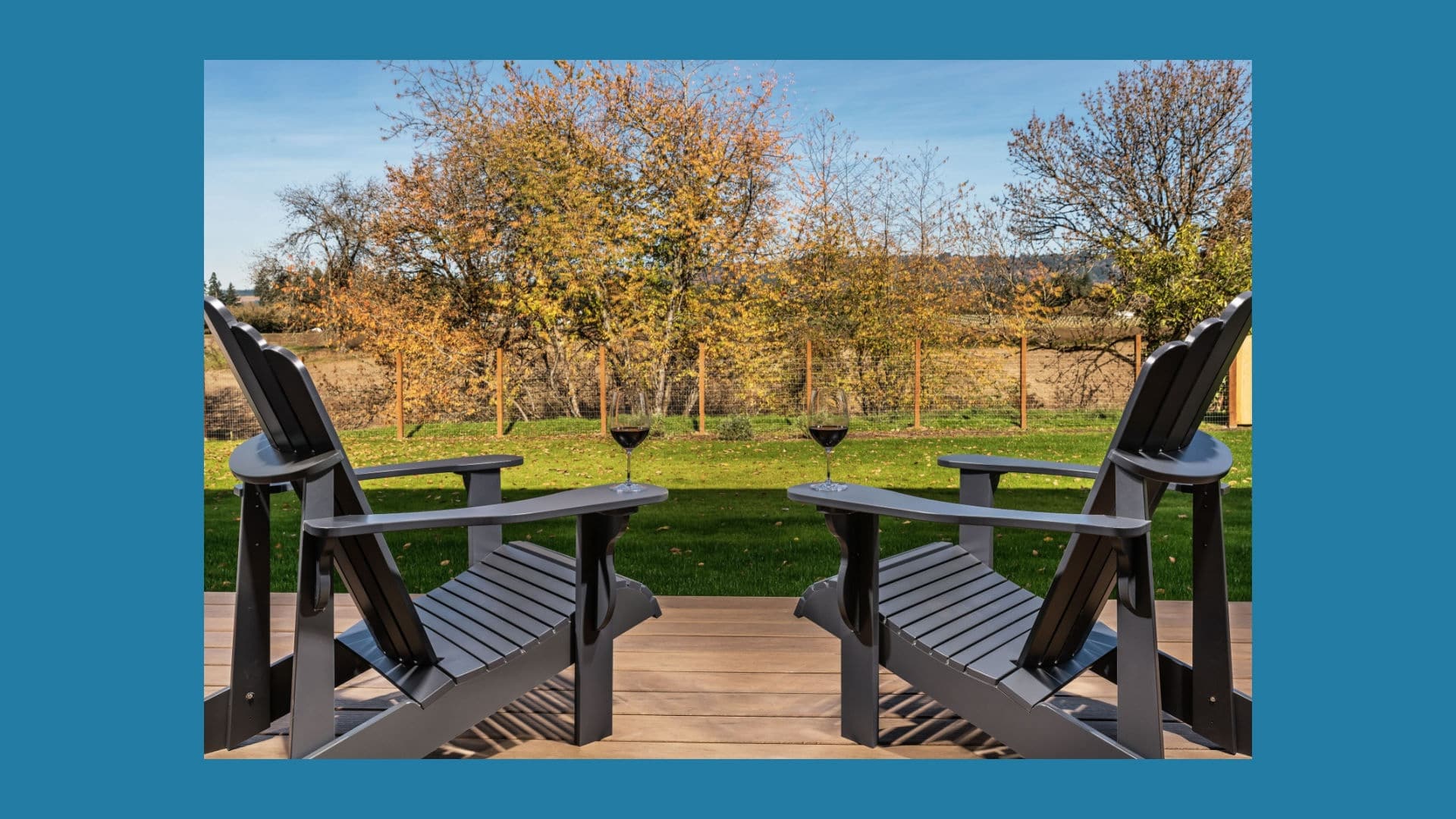 two glasses of red wine on wooden Adirondack chairs in the gardens of the Willamette Valley B&B