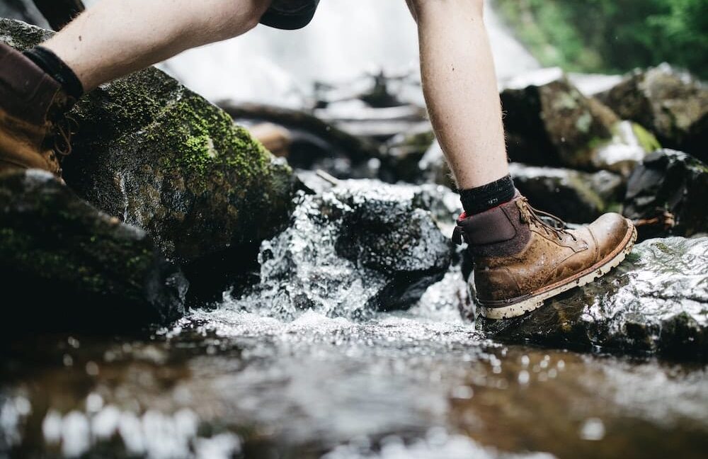 hiking across the creek in hiking boots