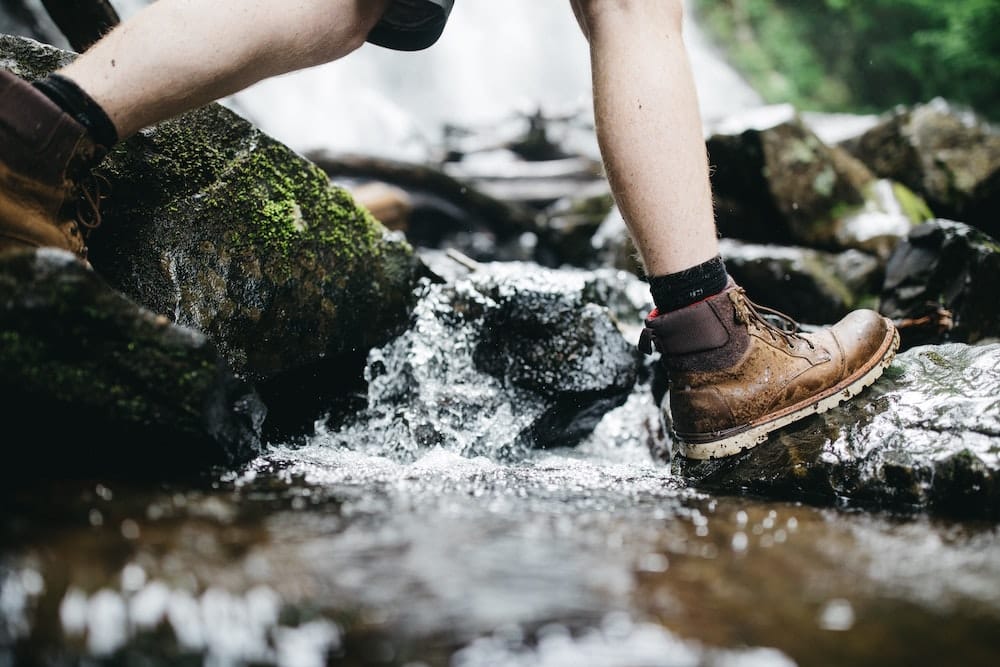 hiking across the creek in hiking boots