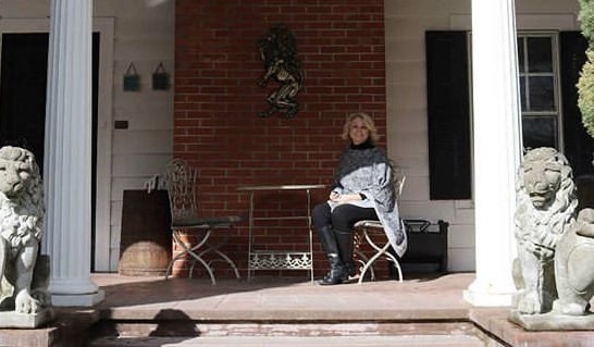 Erin Clark Gilchrist on porch of A'Tuscan Estate