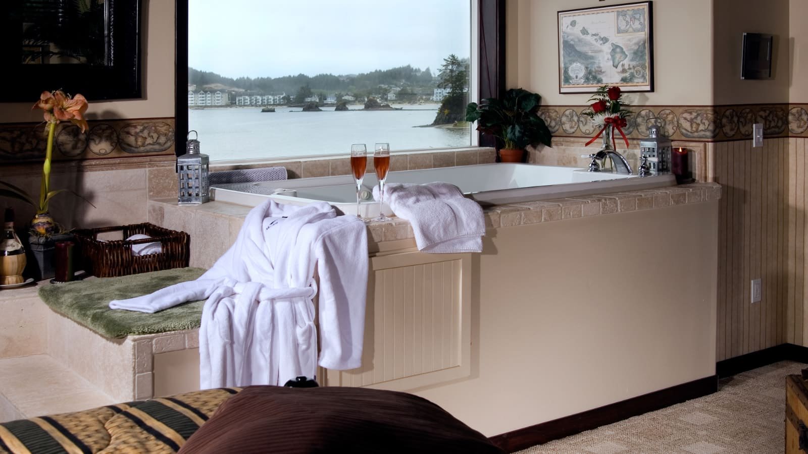 Bedroom with whirlpool tub next to a window looking out over the water