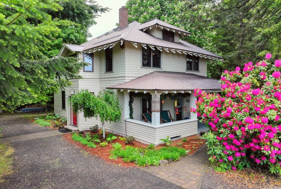 Two story beige house with brown roof and trim. Old Parkdale Inn Bed and Breakfast