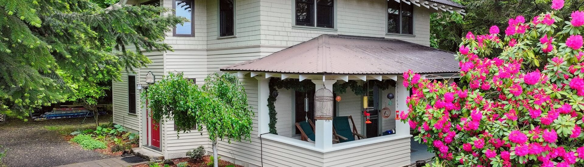 Two story beige house with brown roof and trim. Old Parkdale Inn Bed and Breakfast